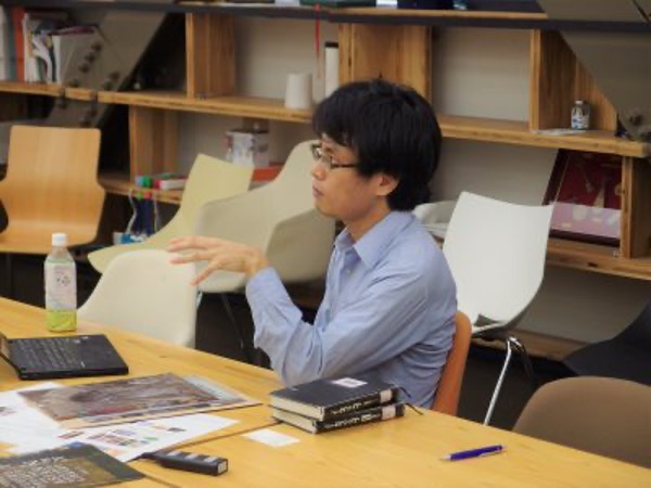 Professor So Morikawa seated at a table